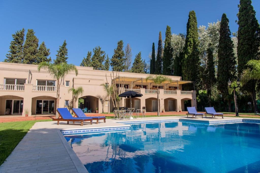 a house with a swimming pool in front of a building at donna emilia in Lobos