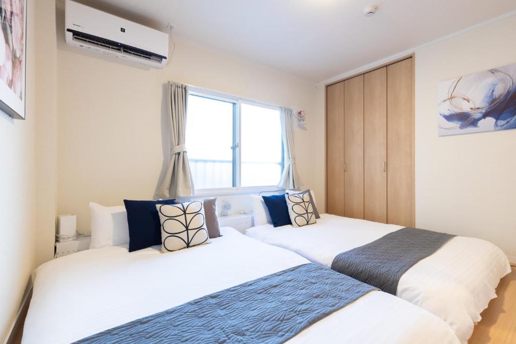 Postel nebo postele na pokoji v ubytování Sakamoto House