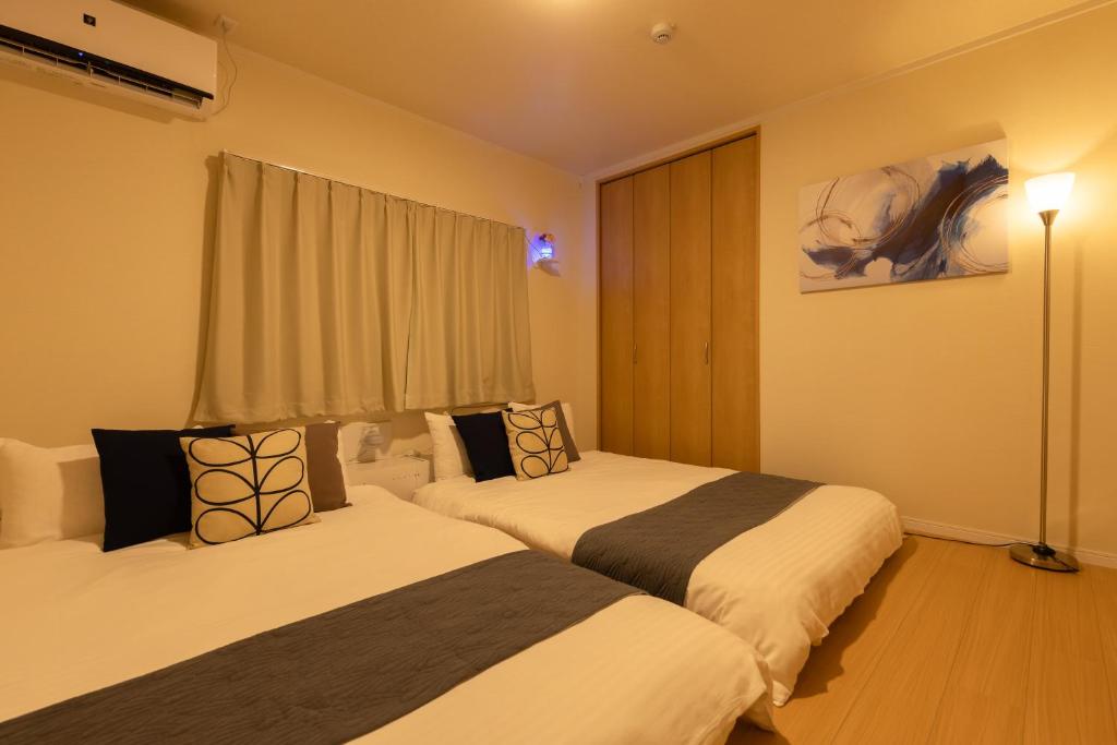 Postel nebo postele na pokoji v ubytování Sakamoto House