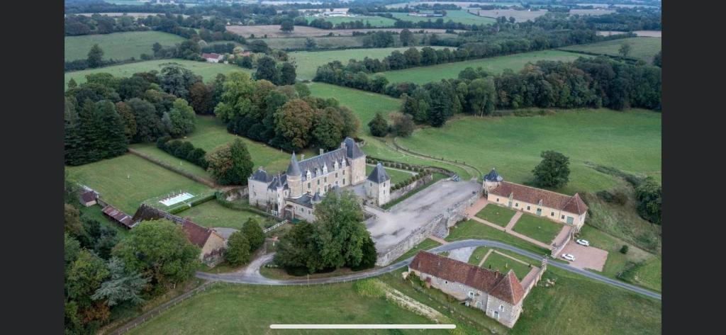 an aerial view of a large castle in a field at Château des Feugerets in Bellême