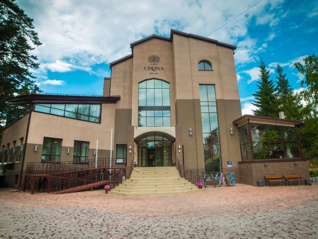 a large building with stairs in front of it at Crona Hotel and SPA in Berdsk