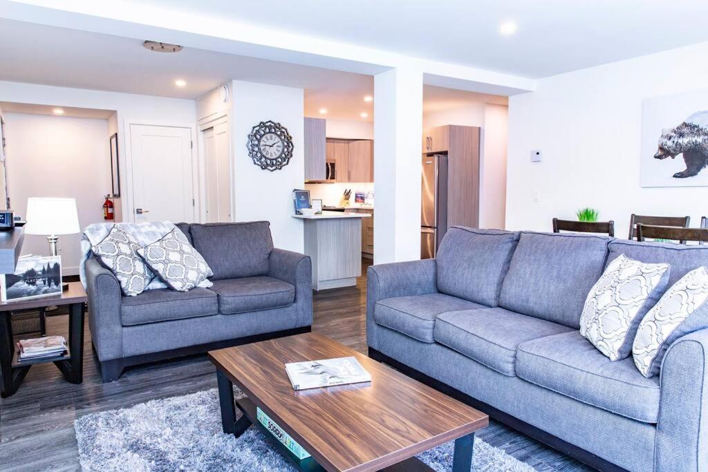 a living room with two couches and a coffee table at Revy Pow Pad - Private Hot Tub 3 Bedroom Condo in Revelstoke