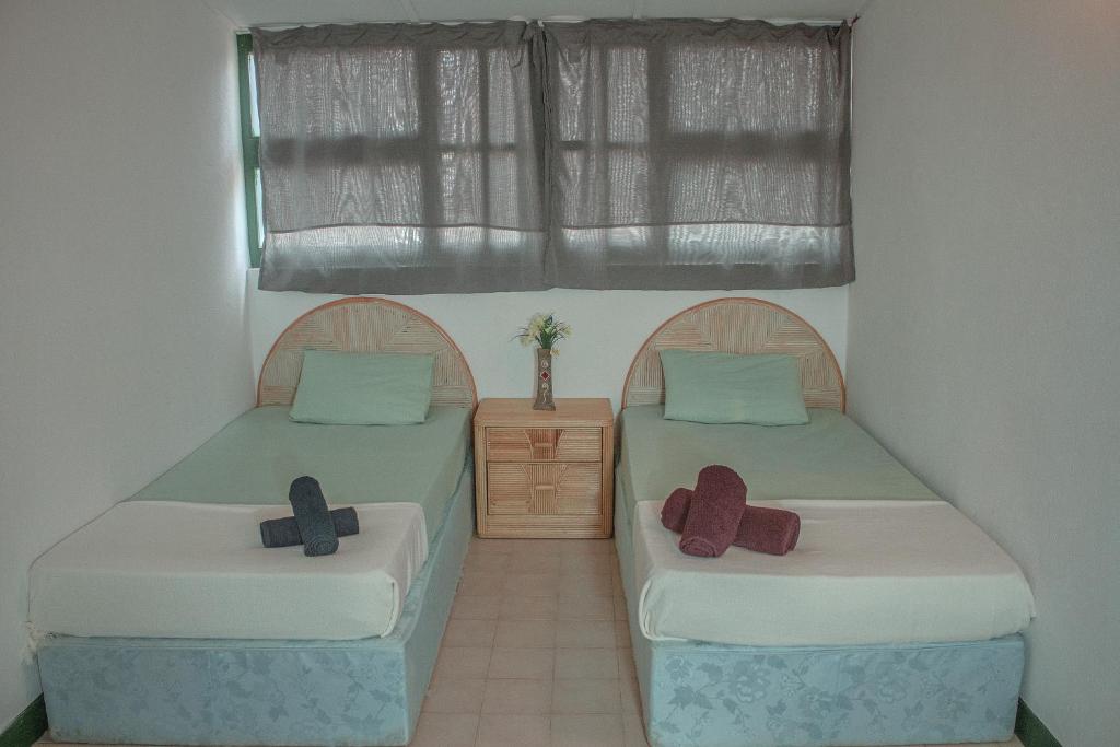 En eller flere senge i et værelse på Vila Paradise Sea & Swimming Pool View