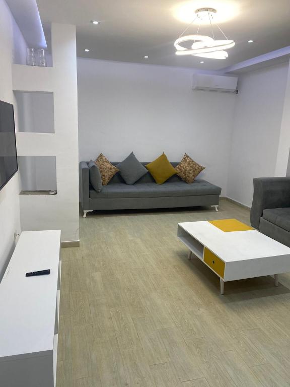 a living room with a couch and a coffee table at Apartment in Soukra in Tunis