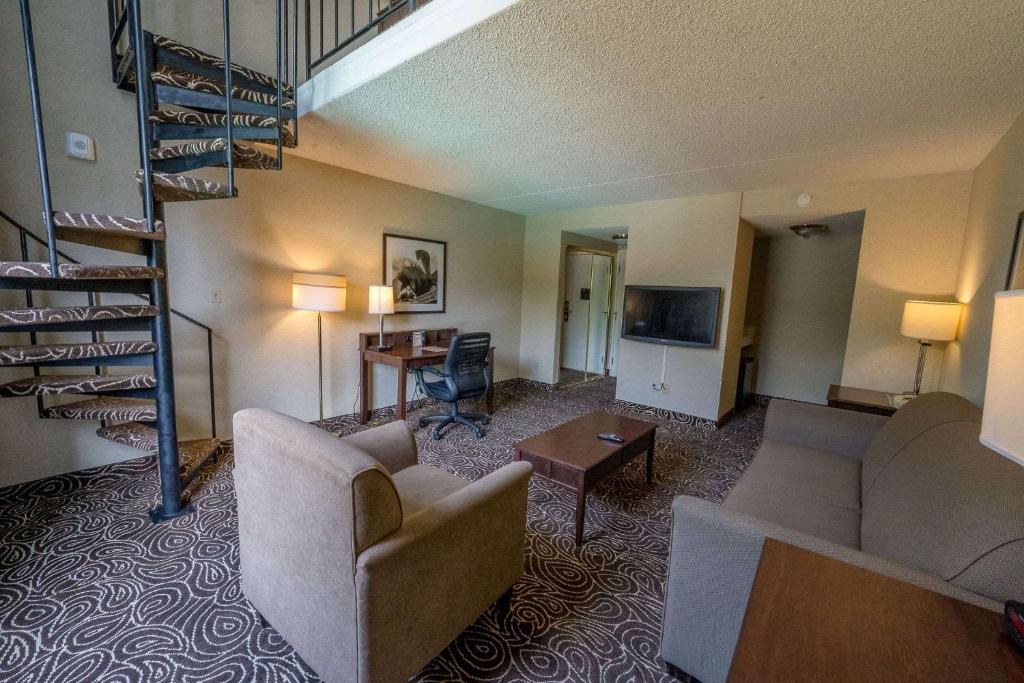 a living room with a couch and a stair case at Hotel 116, A Coast Hotel Bellevue in Bellevue