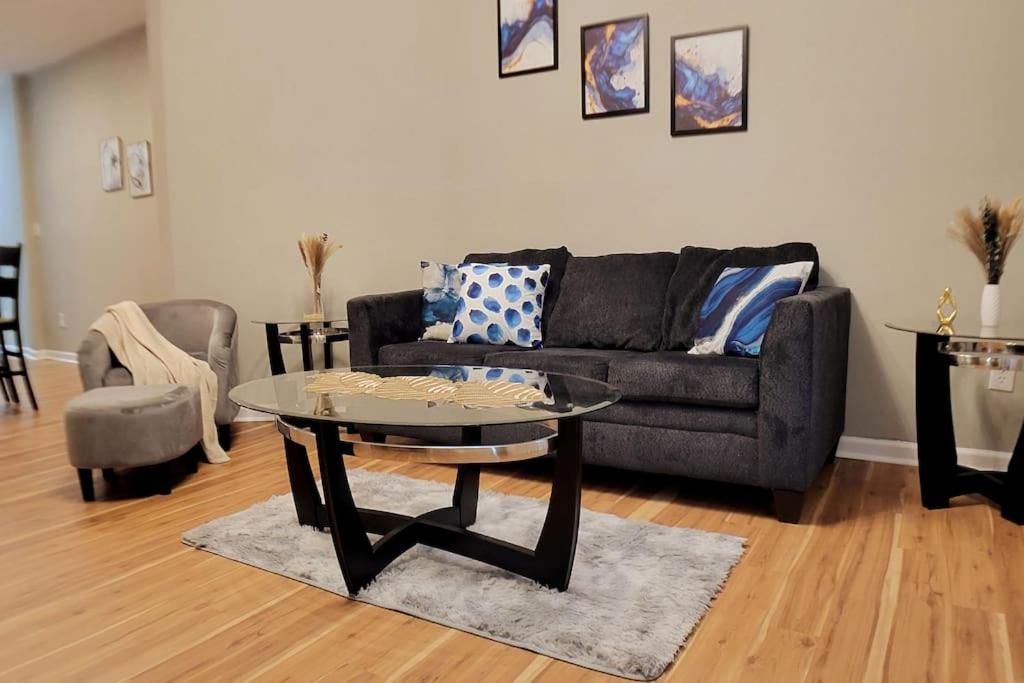 a living room with a black couch and a table at 2 bd 2 bath in Fountain Square- 5 Min to Downtown in Indianapolis