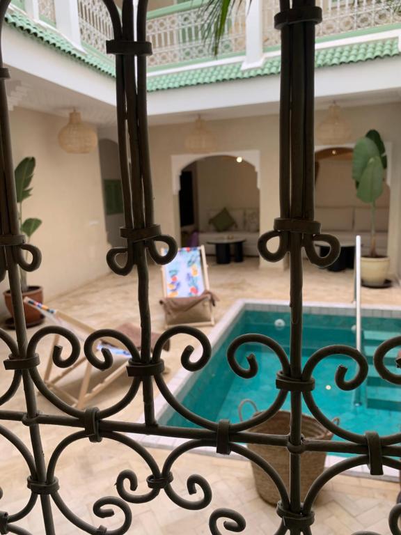 a view of a pool through a fence at Riad Chic in Marrakesh