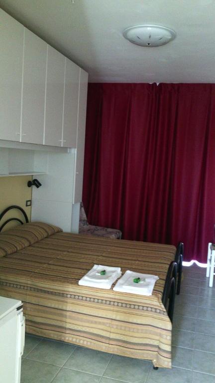 Postel nebo postele na pokoji v ubytování Residence Nettuno
