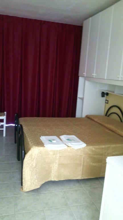 Postel nebo postele na pokoji v ubytování Residence Nettuno
