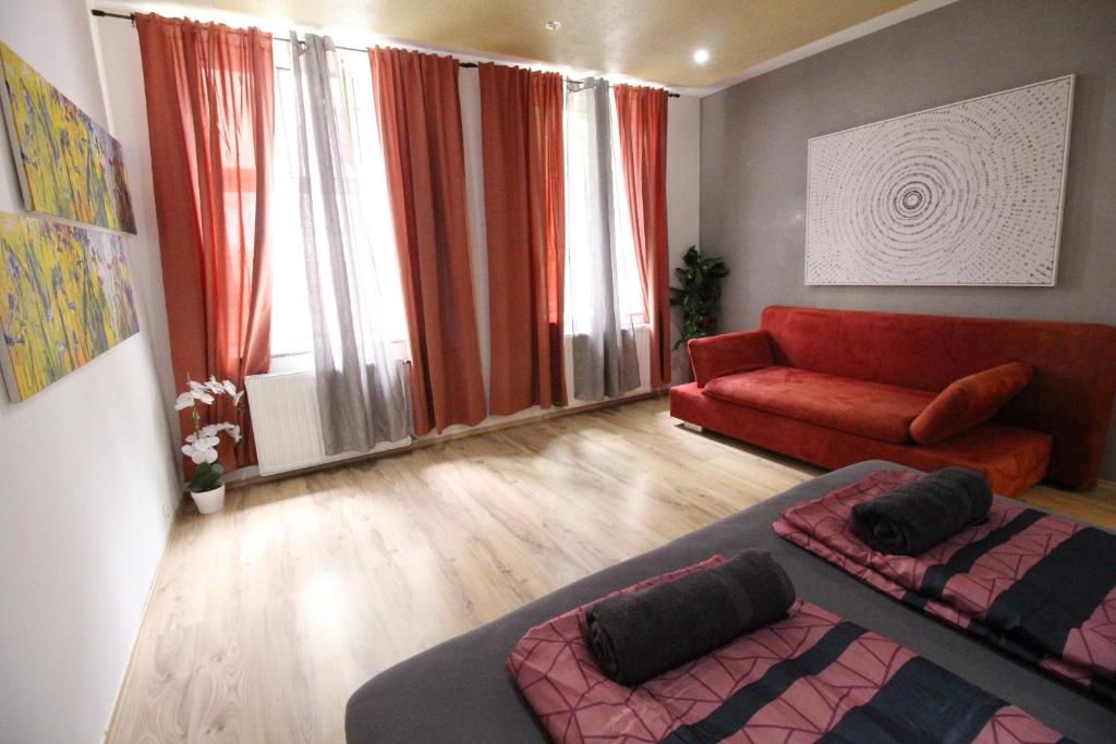 a living room with a couch and a red sofa at Premium Triple room RF in Vienna