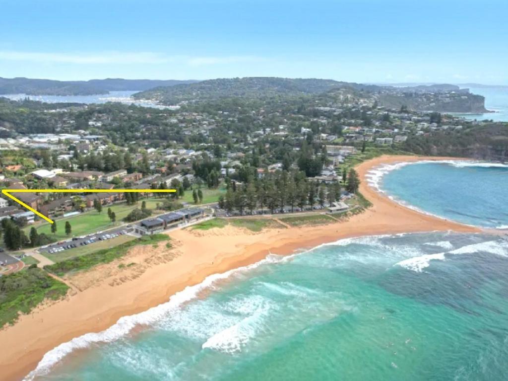 an aerial view of a beach with a yellow rectangle at Reef Resort Apartments in Mona Vale