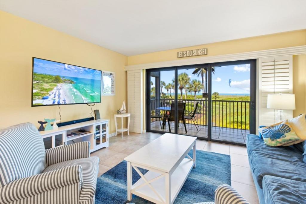 a living room with a couch and a tv at South Seas Beach Villa 2412 condo in Captiva