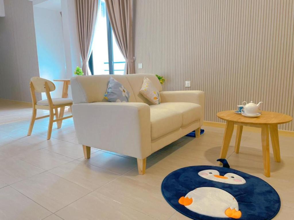 a living room with a couch and a table at Mutiara Melaka Beach Resort in Tangga Batu