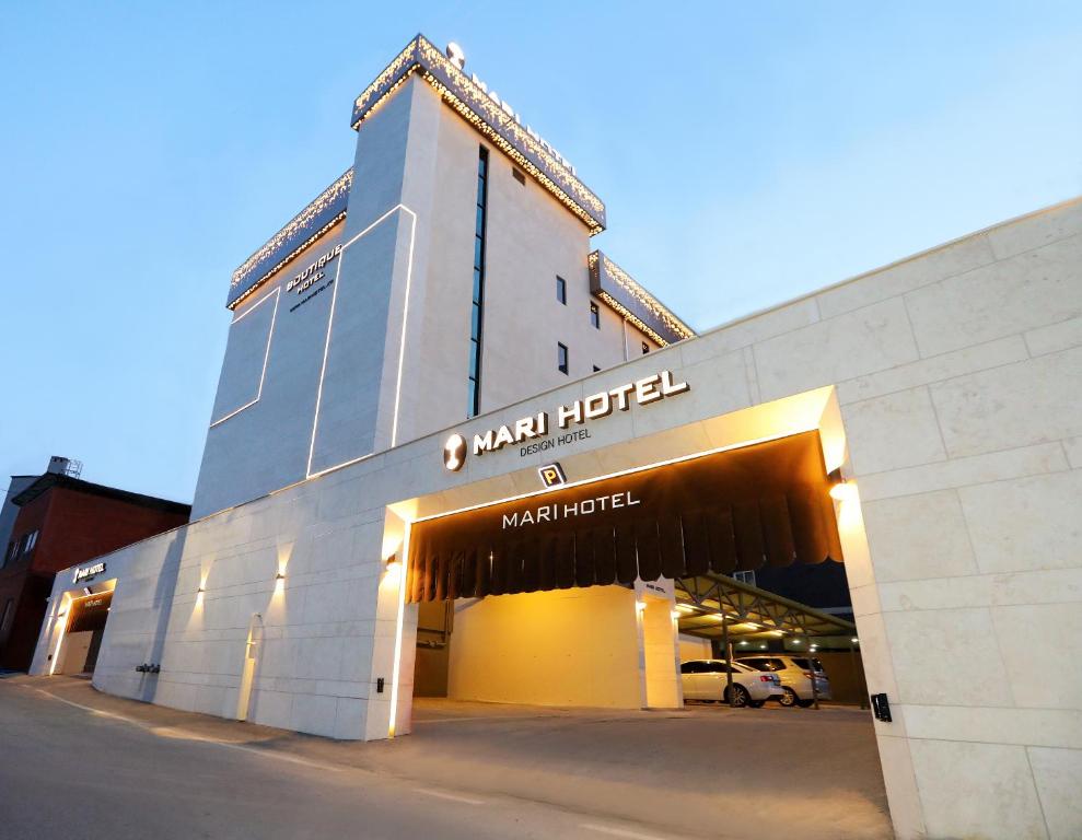 a building with a sign on the front of it at Mari Hotel in Chungju