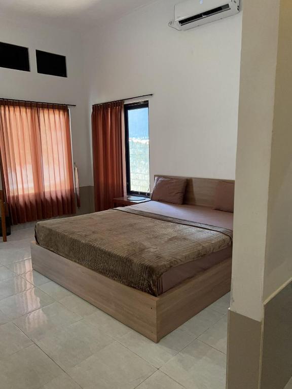 Postel nebo postele na pokoji v ubytování Sayang Bungalows
