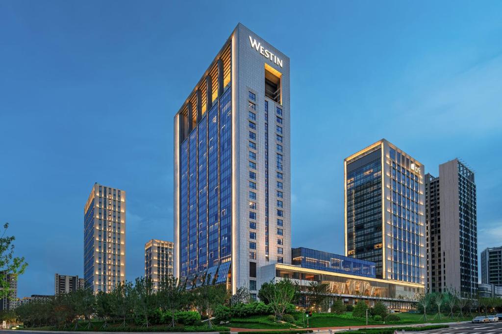 a tall building in the middle of a city at The Westin Yantai in Yantai