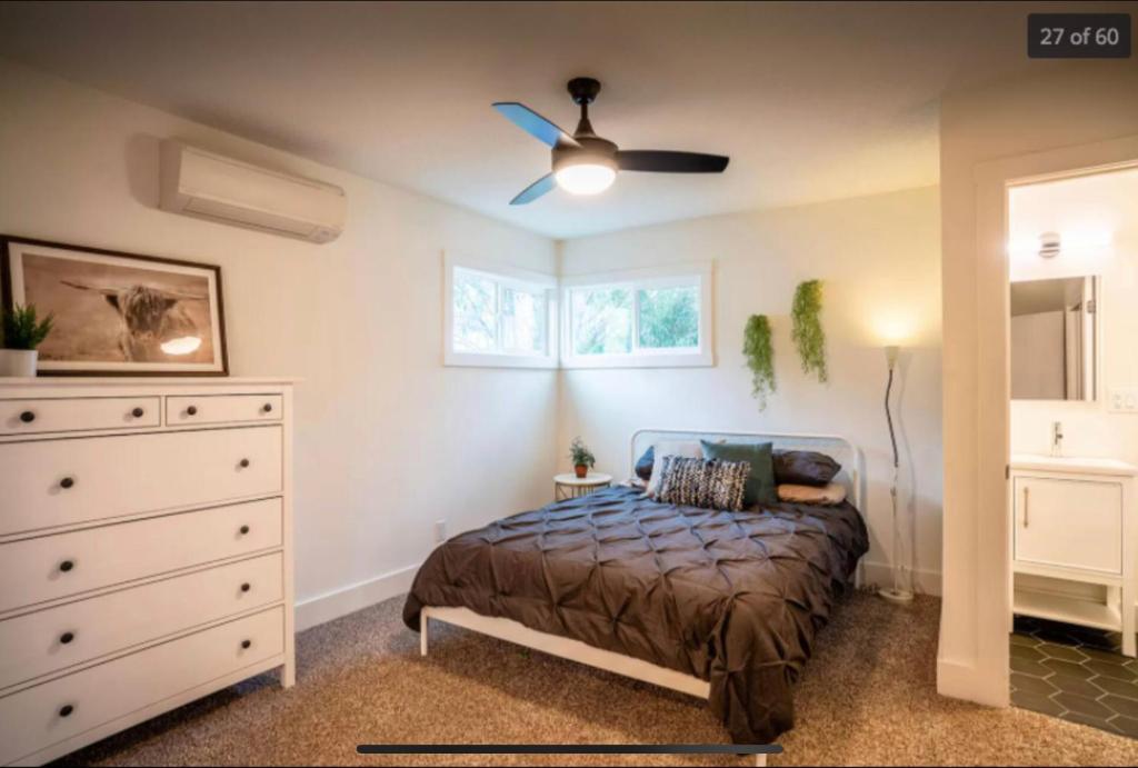 een slaapkamer met een bed en een plafondventilator bij inactive account in Redding