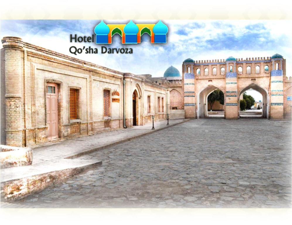 an empty courtyard of an old building with a sign at Qosha Darvoza in Khiva