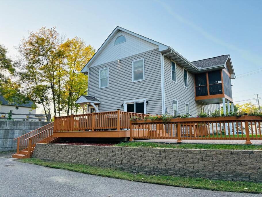 a house with a wooden deck with a fence at Spacious Home Lake Minnetonka Downtown Excelsior in Excelsior