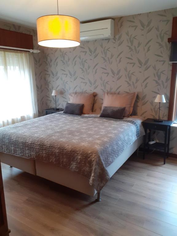 a bedroom with a bed in a room with a wall at Wenceslas Cobergher IV in Bertem