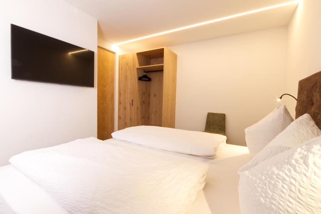 Postel nebo postele na pokoji v ubytování Pension & Residence Astoria