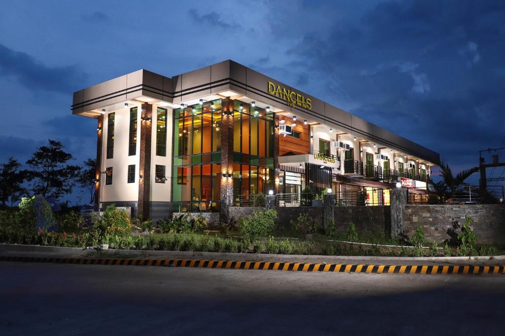 a building with a sign on the front of it at Dancels Inn in Ormoc