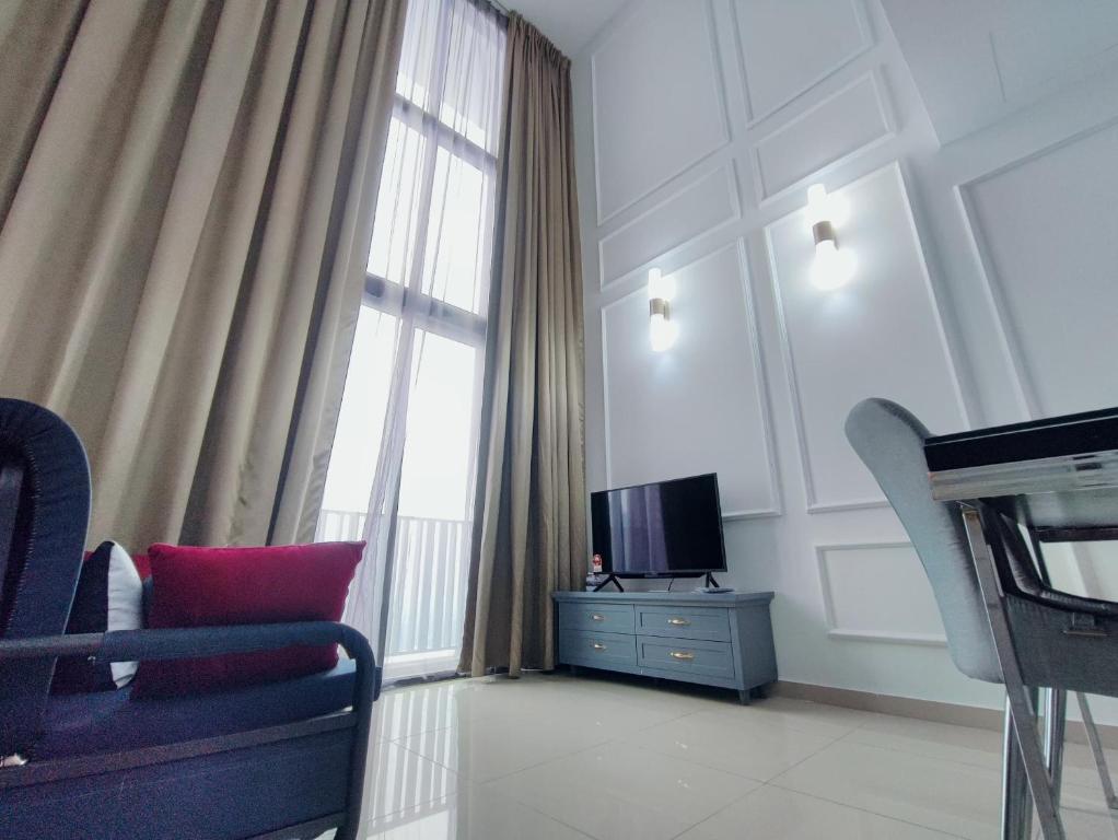 a living room with a tv and a chair and a window at I-City & I-Soho, Shah Alam I-City Mall Walking Distance, Luxury Room in Shah Alam