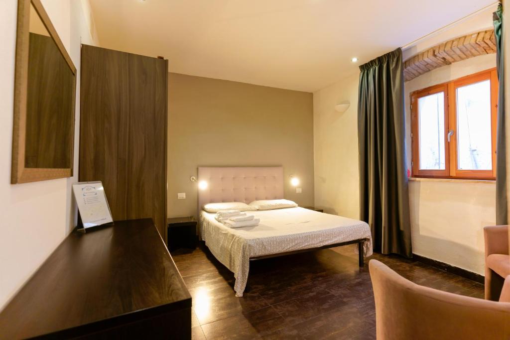 a bedroom with a bed and a desk in a room at Il Palazz8 in Iglesias