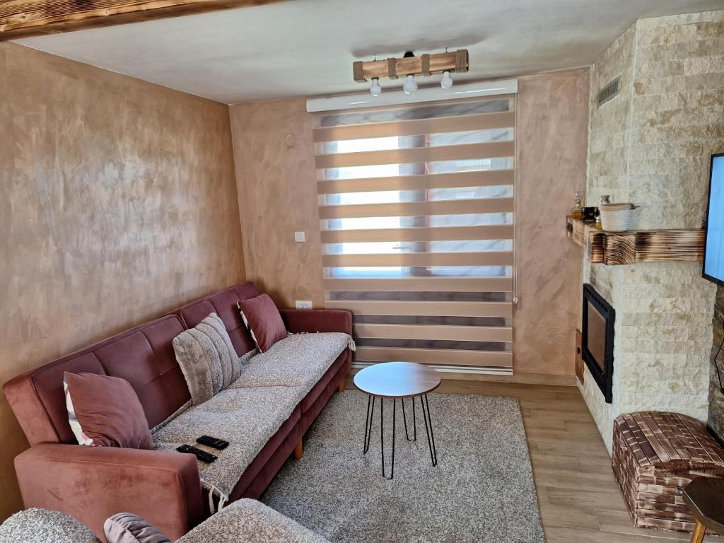 a living room with a couch and a table at Vila Vodice Zlatibor in Vodice