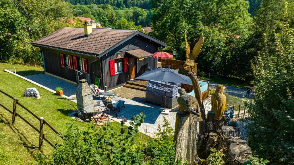 an aerial view of a small house with an umbrella at Altitude 910 in Le Paquier