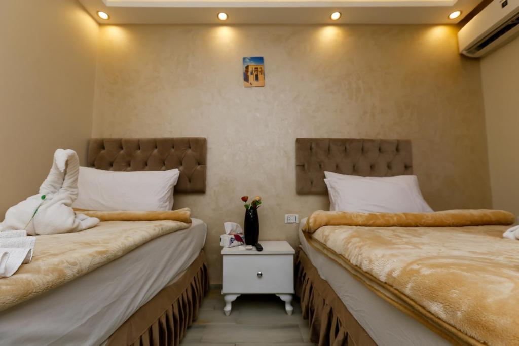 two beds in a room with two beds sidx sidx sidx at Venus Pyramids Inn - Top Roof Access W Free Break Fast in Cairo
