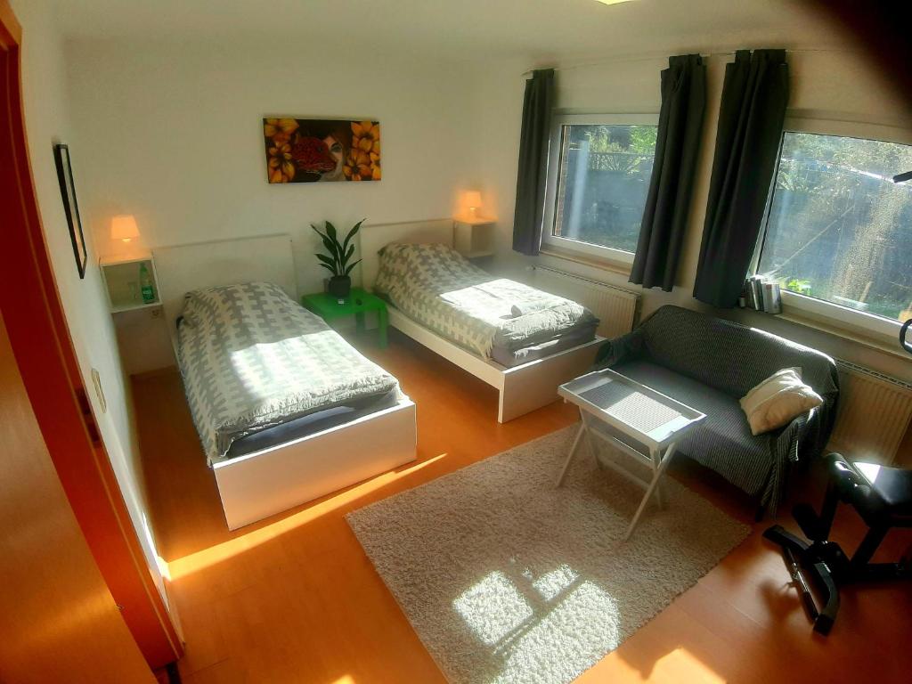a living room with two beds and a couch at 2 Zimmer, Garten, Terrasse, Bad mit Dusche und WC und Gemeinschaftsküche in Ilsede