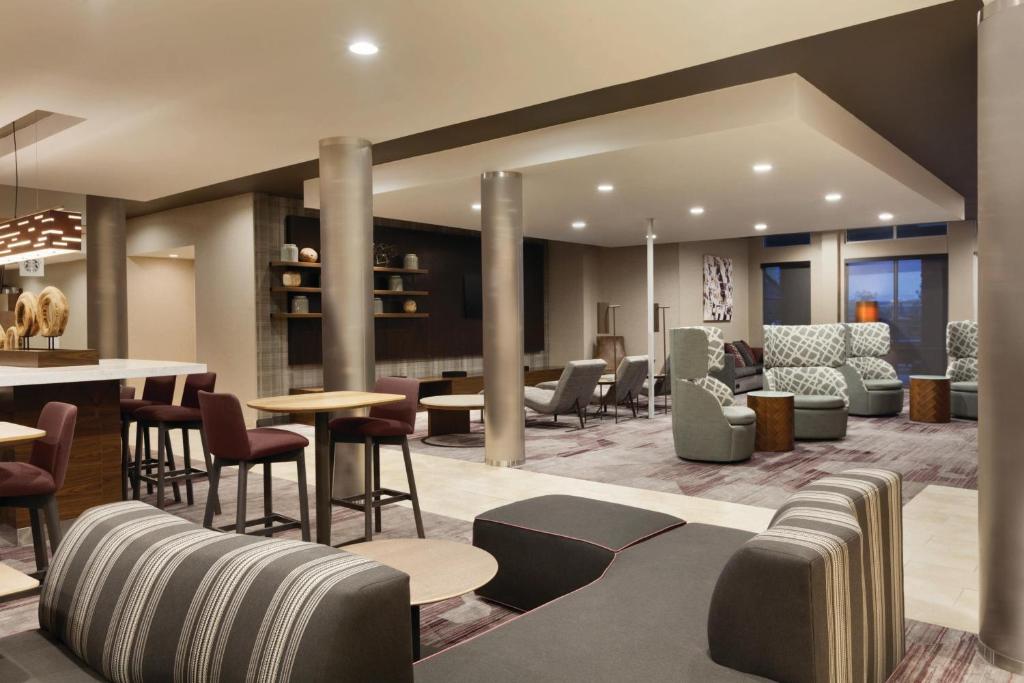 a lobby of a hotel with tables and chairs at Courtyard by Marriott El Paso East/I-10 in El Paso