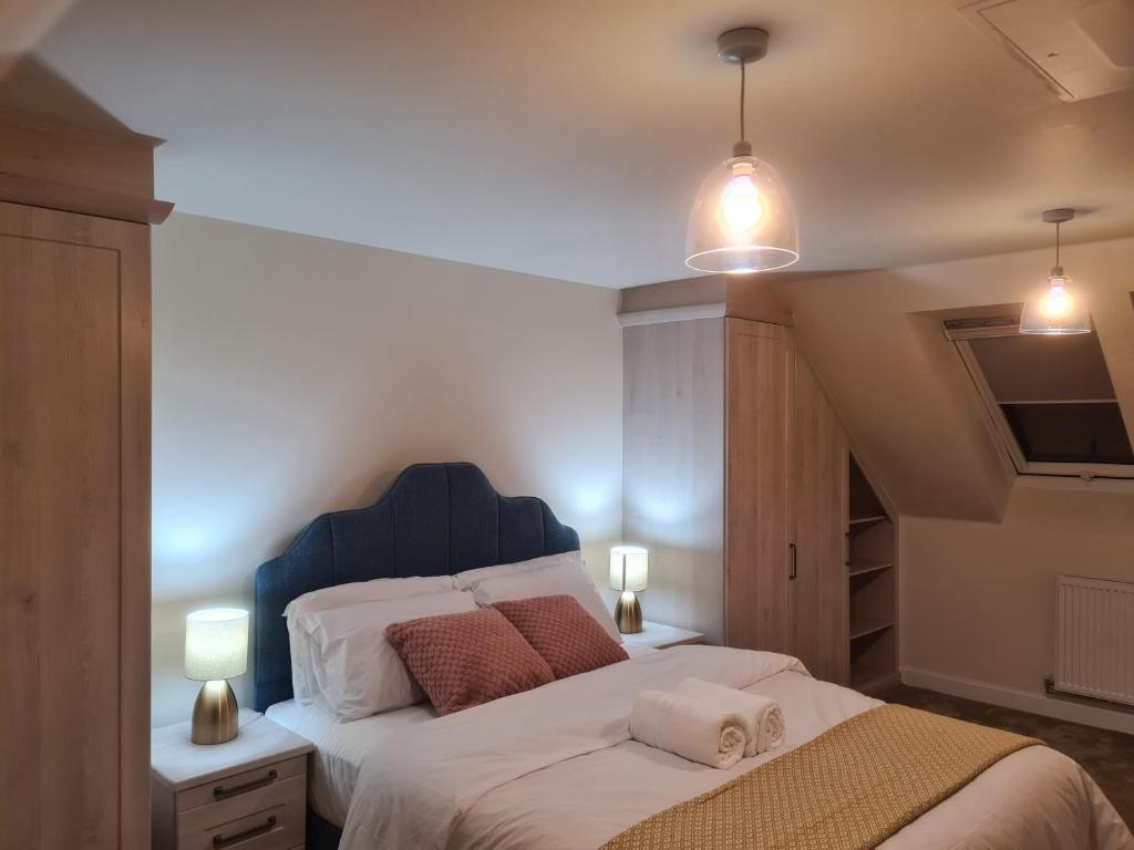 a bedroom with a large bed with two towels on it at Sky's Haven in Sunningwell