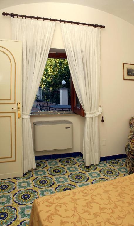 Postel nebo postele na pokoji v ubytování Hotel Rufolo