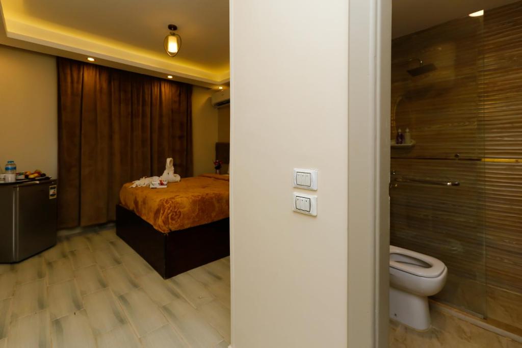 a bathroom with a bed and a toilet at Venus Pyramids Inn - Top Roof Access W Free Break Fast in Cairo