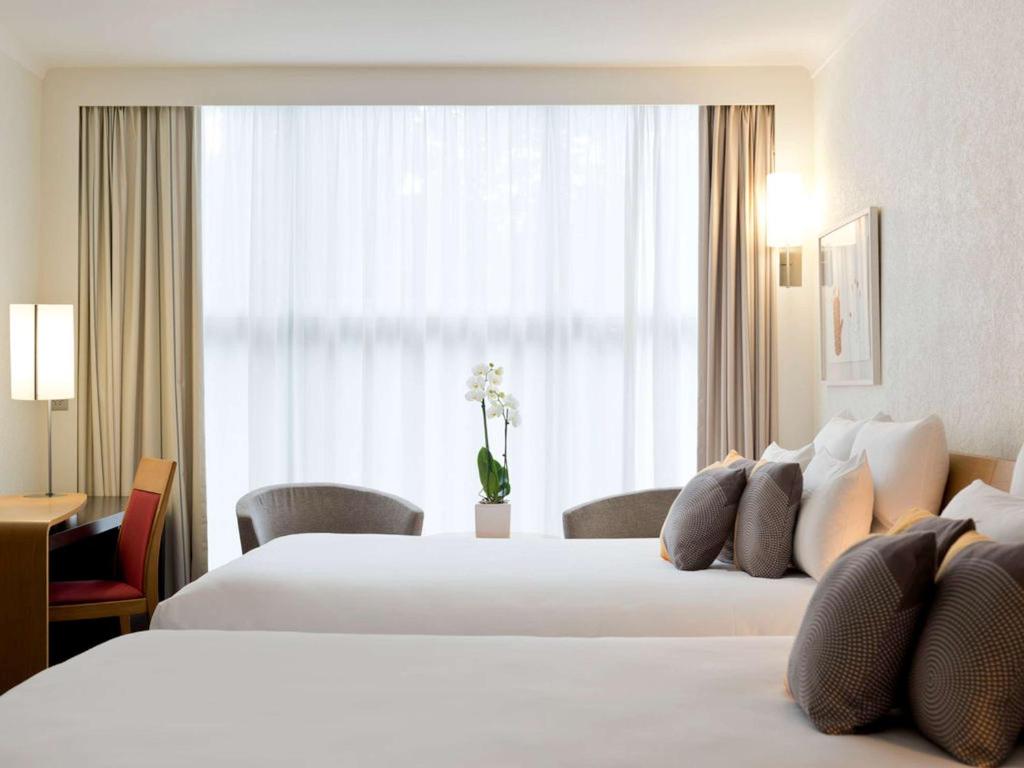 Postel nebo postele na pokoji v ubytování Novotel Genève Centre