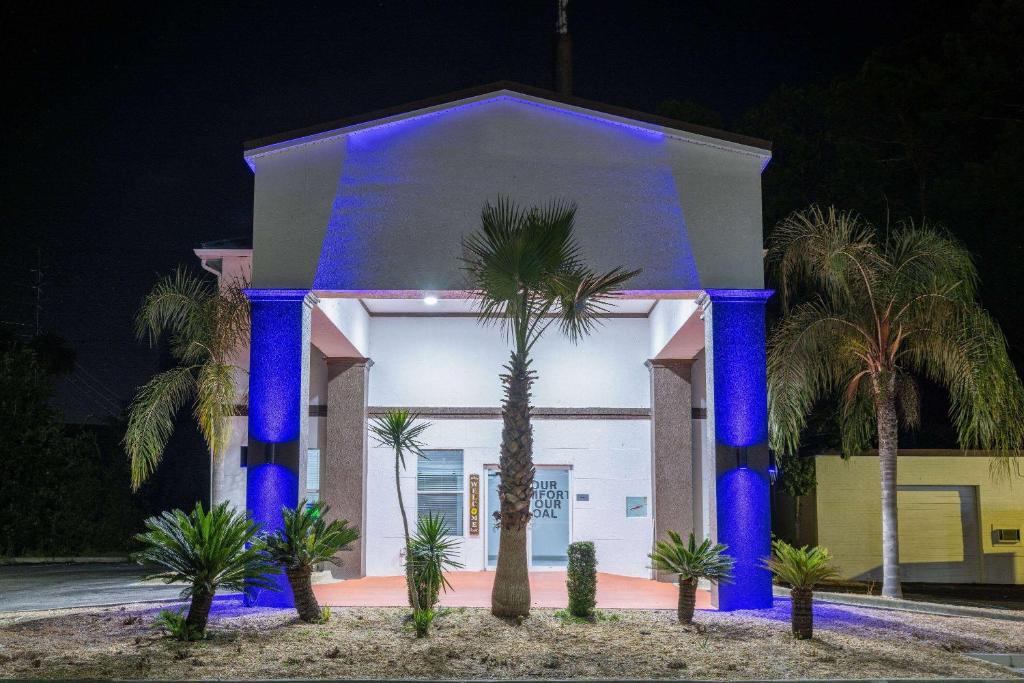 a house with blue lights on the front of it at Travelodge by Wyndham Kingsland GA in Kingsland