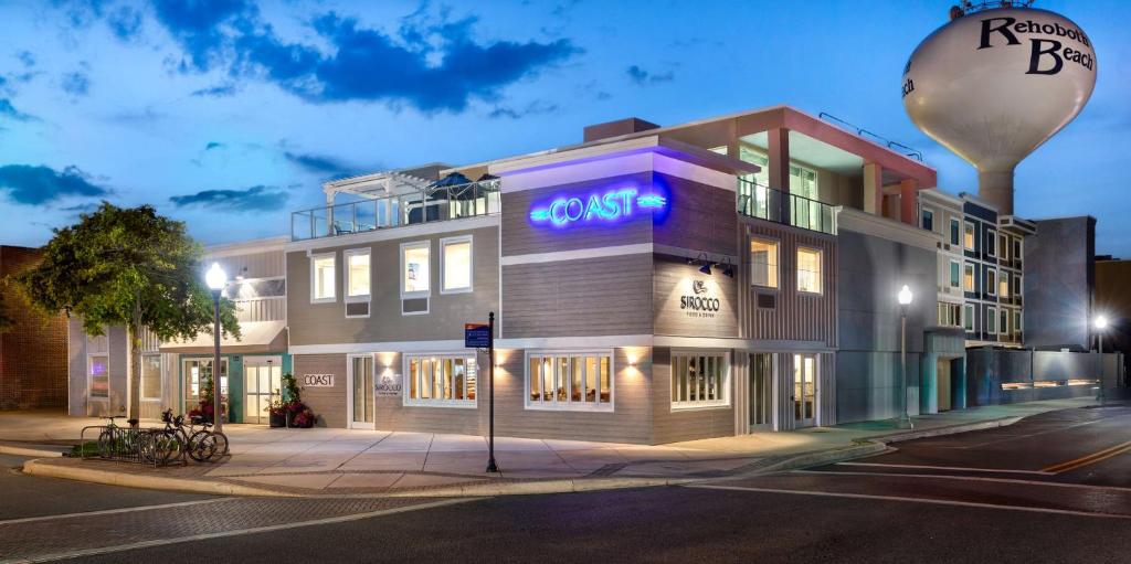 a building with a neon sign on the side of it at Coast Rehoboth Beach, Tapestry Collection By Hilton in Rehoboth Beach