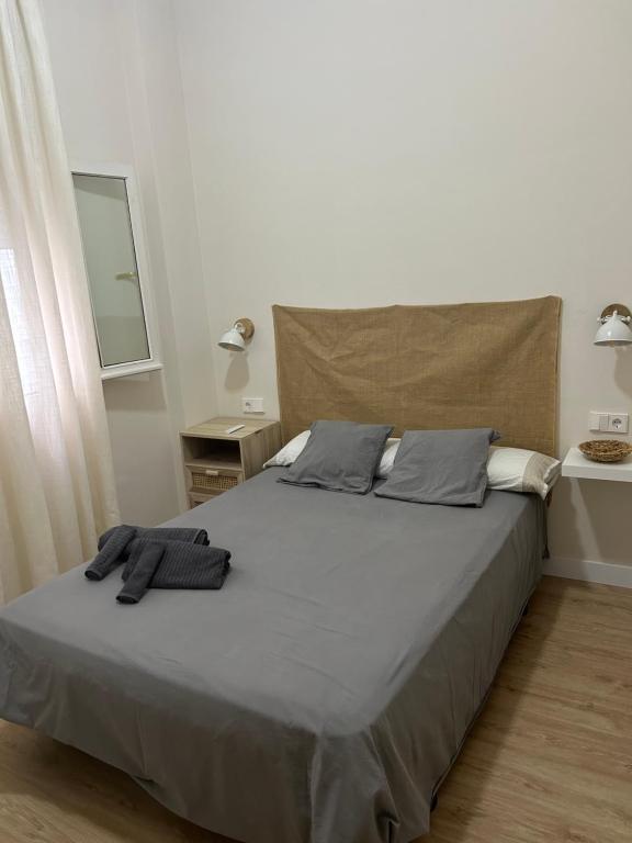 a bedroom with a bed with two pillows on it at Habitación en Plaza Mina in Cádiz
