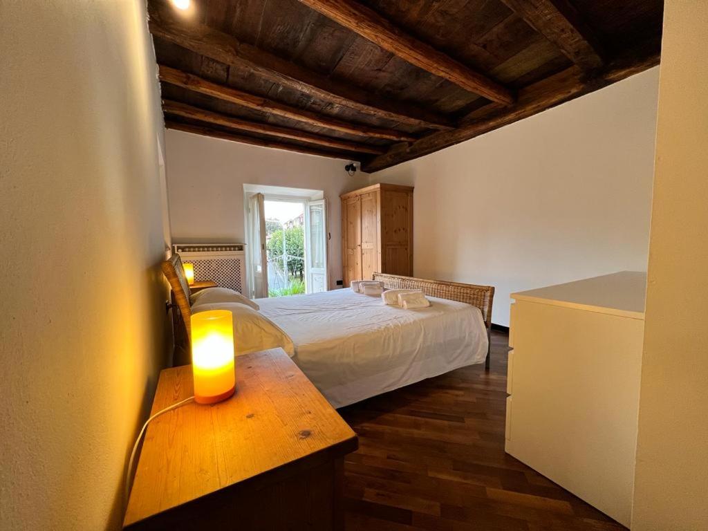 a bedroom with a bed and a candle on a table at Kibilù - Via Robarello - Sacro Monte in Varese