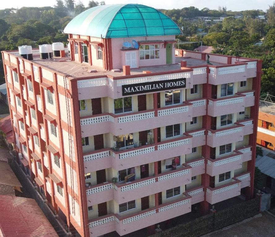 Un bâtiment avec un panneau en haut dans l'établissement MAXIMILIAN HOMES, à Kilifi