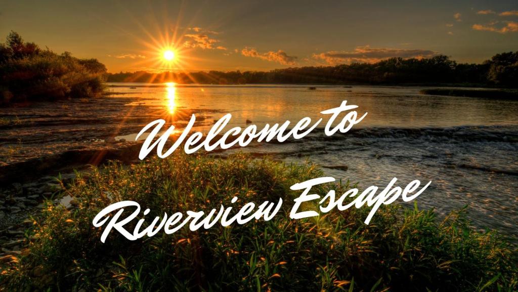 a sunset over a river with the words welcome to riverhen escape at Riverview Escape - Cabins on the Ohio River 