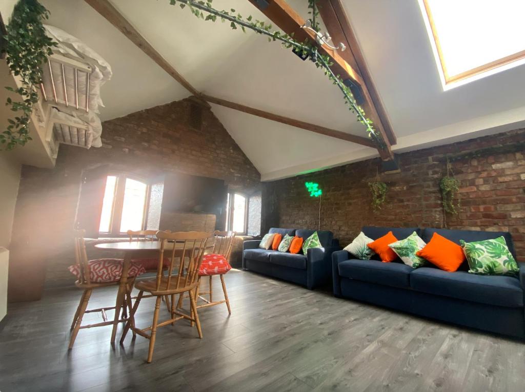 a living room with a blue couch and a table at Button Street by UStay Aparthotels in Liverpool