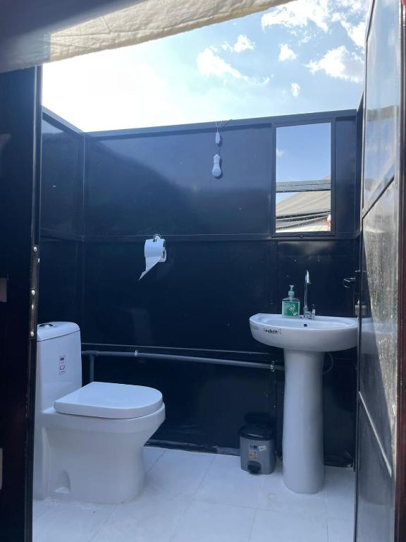 a bathroom with a toilet and a sink at Moon Light Camp in Bidiyah