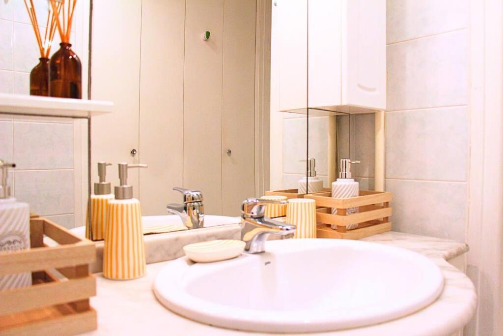 a bathroom with a white sink and a mirror at Un cocon face à la mer in Plérin