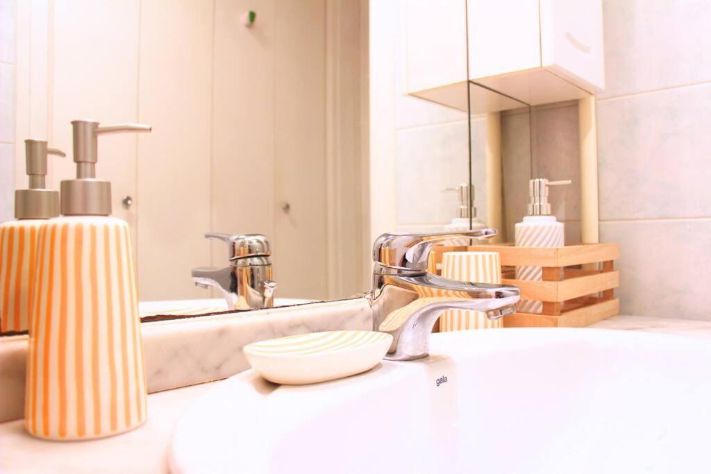 a bathroom with a sink and a soap dispenser at Un cocon face à la mer in Plérin