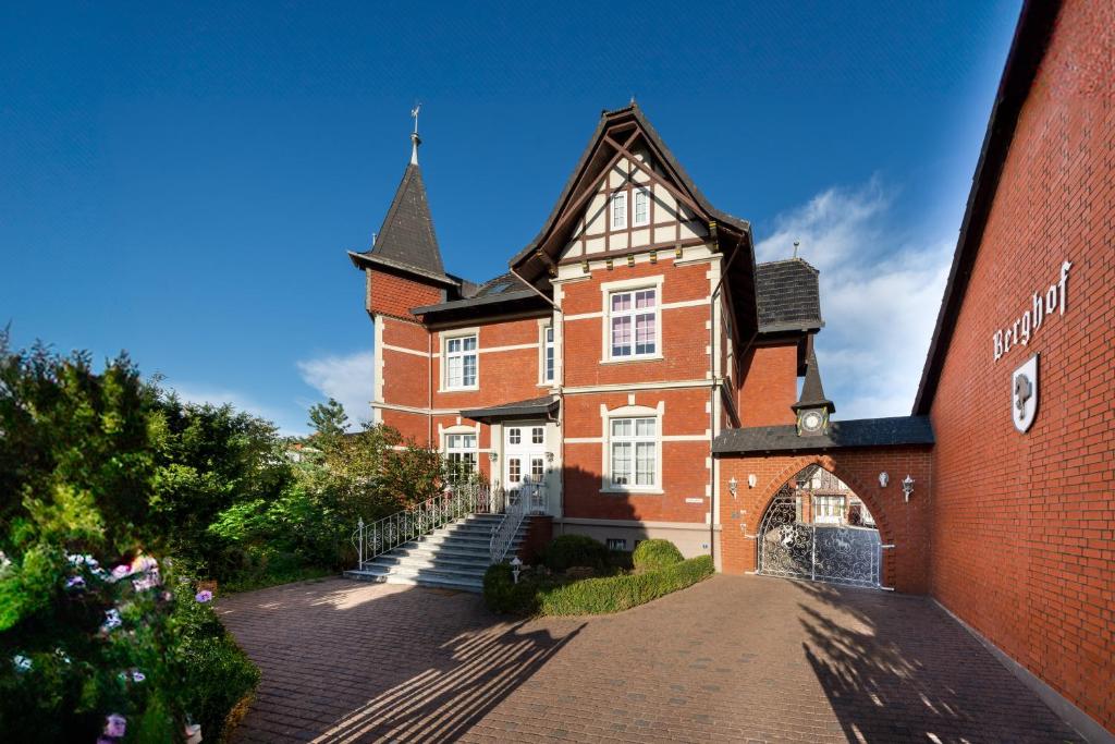 a large red brick building with a blue sky at Apartments - Privatstall am Berghof in Einbeck