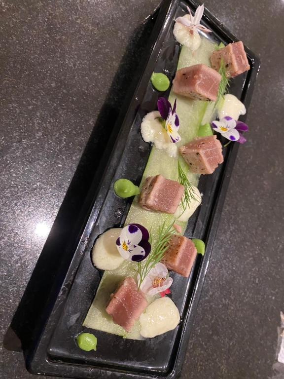 a plate of food with sushi on a table at Peach on Beach Boutique Guesthouse in Bloubergstrand