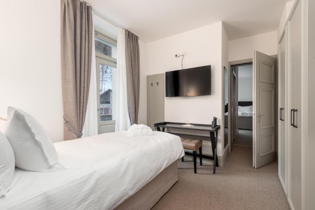 Postel nebo postele na pokoji v ubytování Villa Carona Hotel & Spa